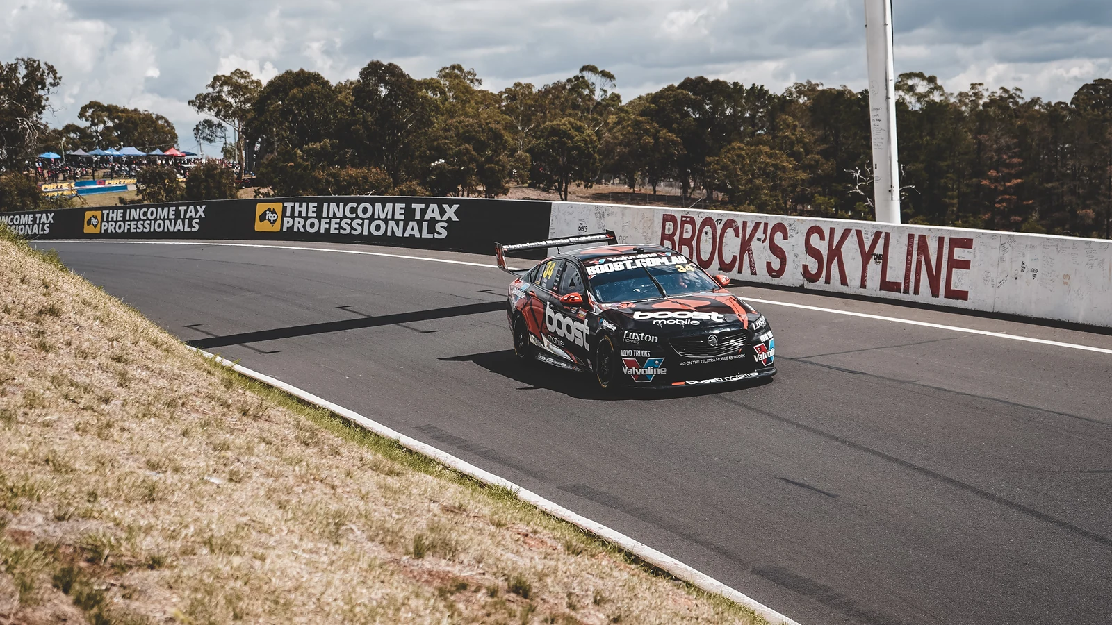 Race car through the Brock's Skyline corner at Mount Panorama, Bathurst