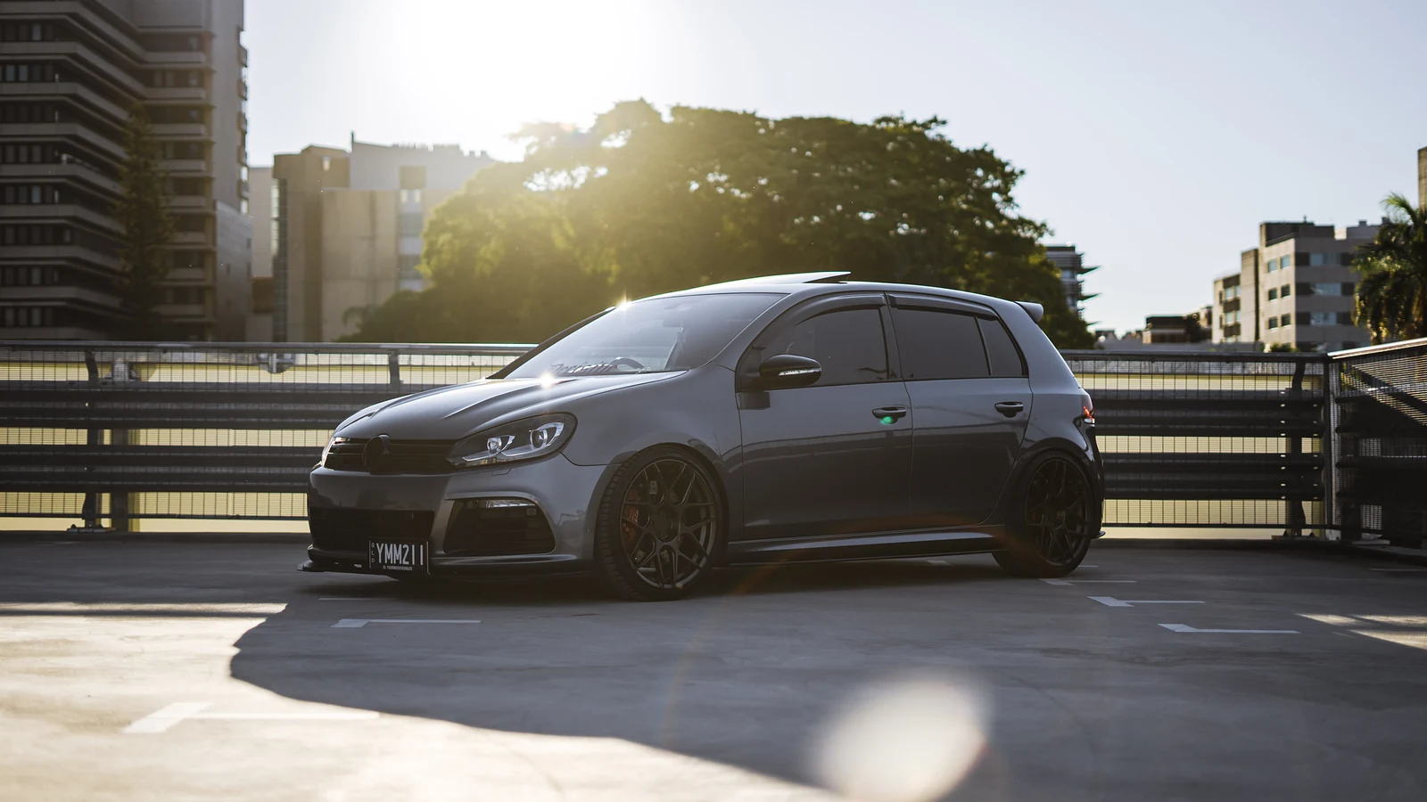 Grey Golf R on a rooftop car park with the sun behind the trees