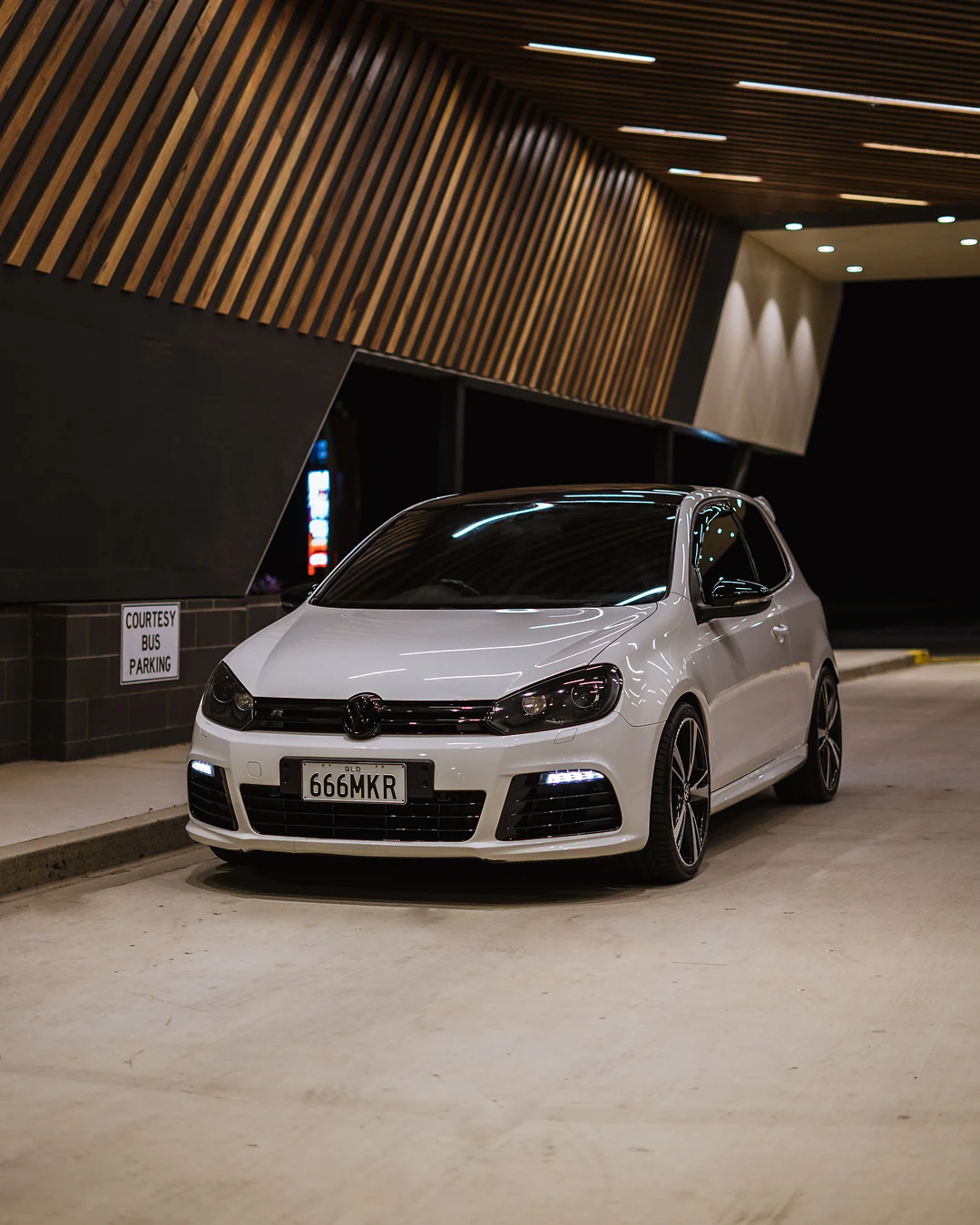 White Golf R under a timber slat ceiling in a car park