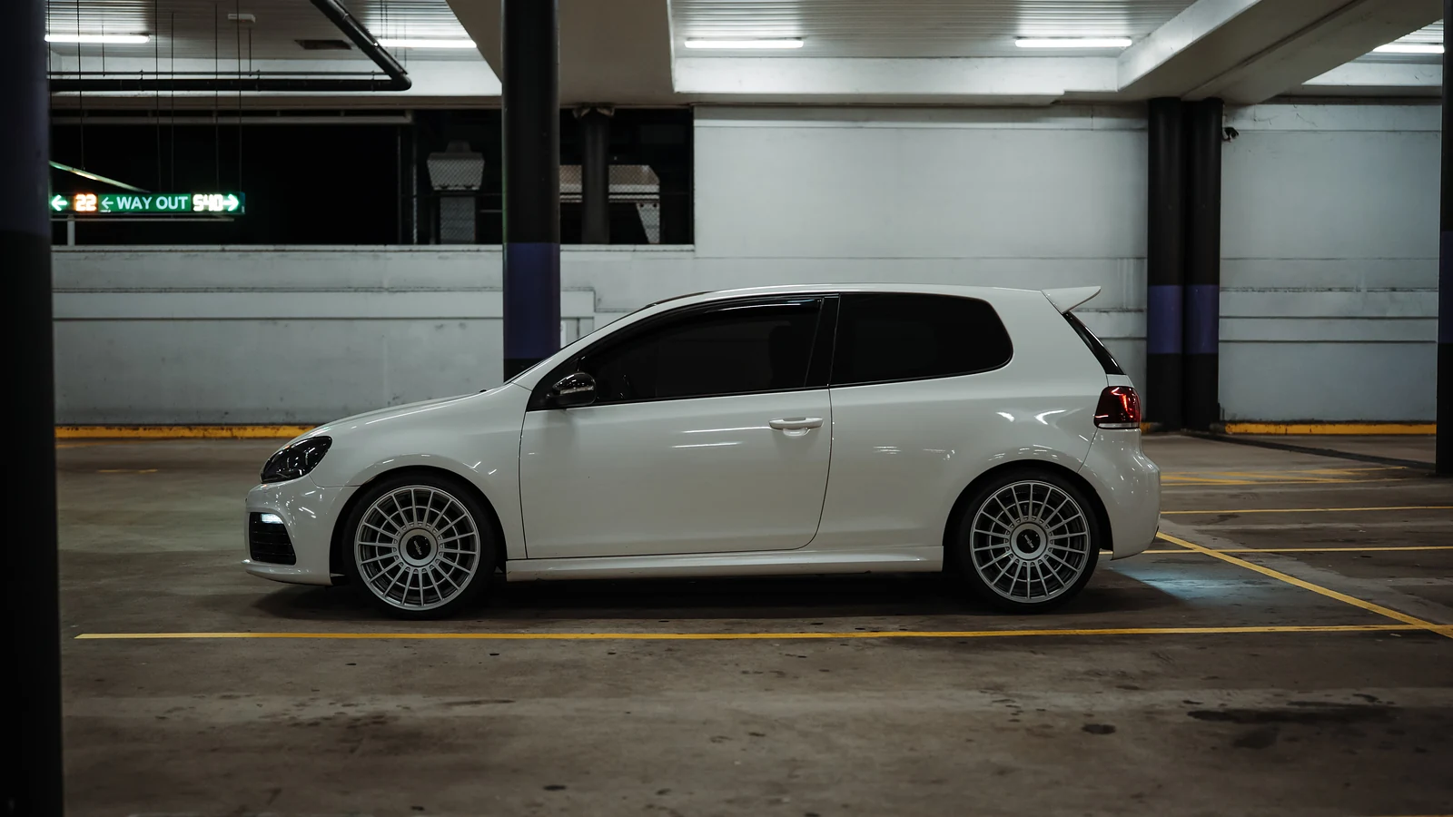 White Golf side profile in an underground car park
