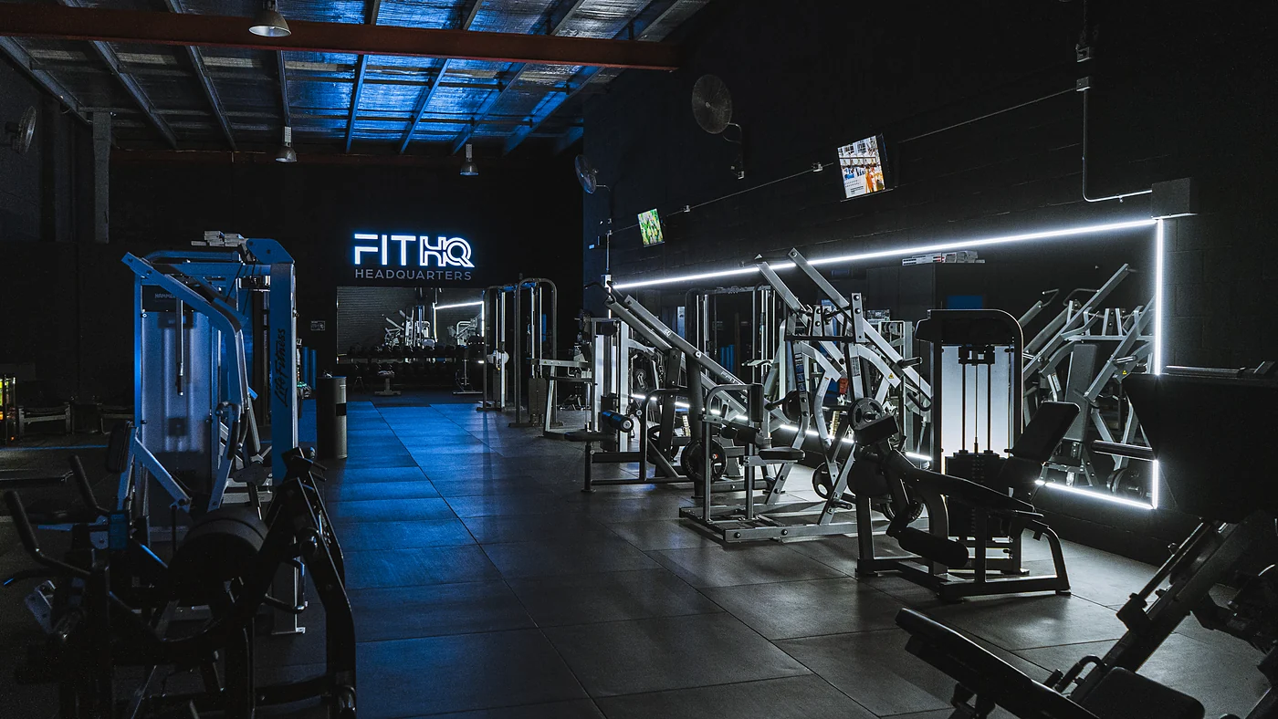 Empty gym floor with the equipment lit and the lights on
